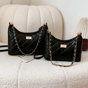 Quilted black leather shoulder bag set with gold chain and turn-lock closure