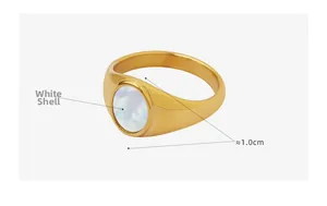 Detailed view of 1cm wide golden ring featuring a natural oval white shell inlay