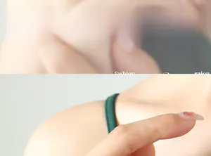 Close-up of deep green elastic hair tie made from knitted fabric shown on model wrist
