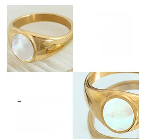 Detailed view of an 18K gold plated titanium ring featuring a white seashell inlay
