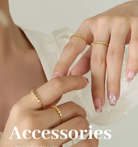 Close-up of gold-plated stacking rings with zircon stones on a model's hand