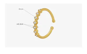 Macro detail of gold-plated copper ring featuring seven sparkling round zircons
