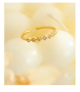 Detail view of 18K gold plated geometric ring with sparkling cubic zirconia inlays