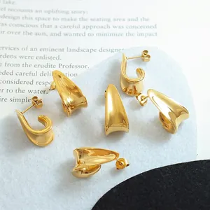 Three pairs set of 18K gold plated titanium steel irregular curved earrings on magazines