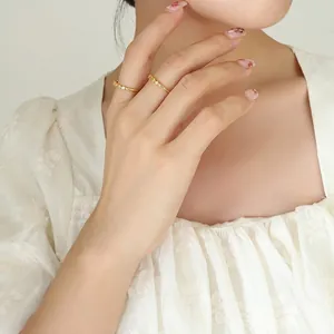 Minimalist gold plated copper ring set with seven zircon stones worn on fingers