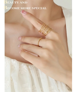 Detail of layered gold-plated wrap ring paired with a sparkling pave zircon band