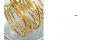 Macro shot of minimalist multi-layer spiral copper ring with polished gold plating