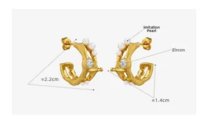 Detail view of gold C-shape earrings with imitation pearl and zircon, size 2.2cm x 1.4cm
