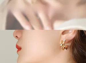 Close-up of French vintage gold C-shape earring with pearls and zircon on model ear