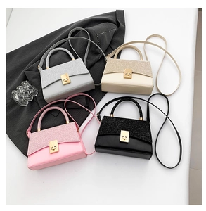 Top view of mini square handbags in silver, gold, pink, and black with glitter texture