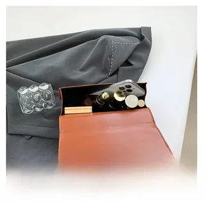 Detail view of brown crocodile pattern bag showing spacious interior for daily essentials