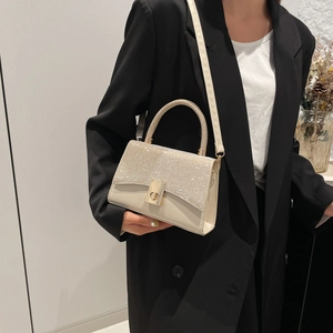 Minimalist cream leather crossbody bag with shimmering sequin flap and gold clasp