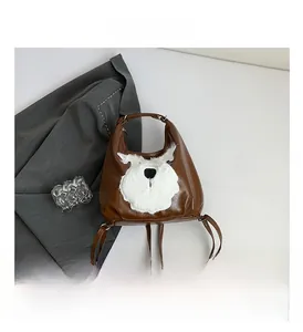 Detail view of brown PU leather backpack with a white plush dog face mascot decoration