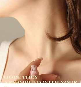 Detailed view of pink gradient press-on nails with heart and rabbit patterns and small gems