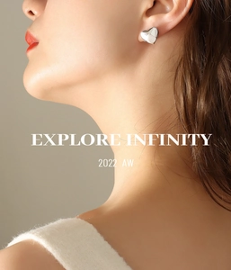 Polished silver heart-shaped stud earring shown on model with smooth mirror finish