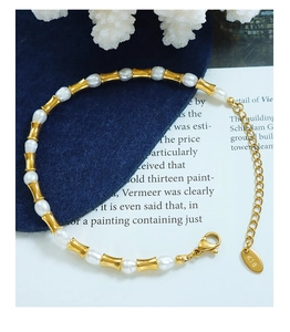 Dettaglio del bracciale con perle d'acqua dolce e maglie in oro 18K con targhetta K18 e gancio