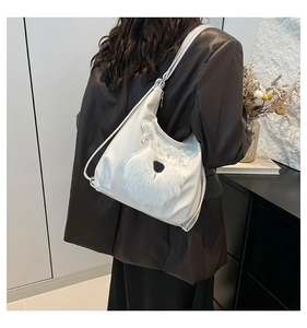 Detailed side view of large white tote bag with faux fur dog patch on minimalist leather