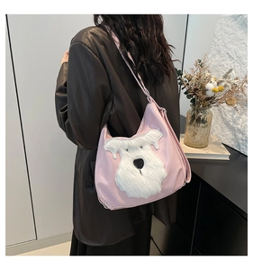 Detail of pink hobo shoulder bag with a cute white faux fur puppy embroidery
