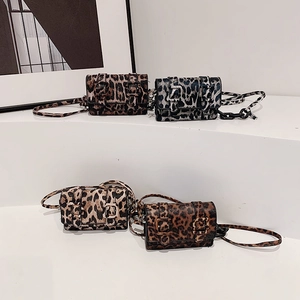 Mini leopard print crossbody bags in various colors on white modern display stands