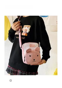 Detail of pink canvas crossbody bag with cute bear ears and adjustable shoulder strap