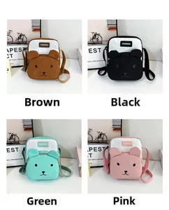 Detail view of cartoon bear crossbody bags in brown, black, green, and pink colors