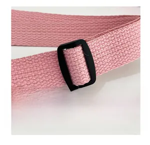 Detailed shot of pink woven shoulder strap with black matte adjustable buckle for crossbody bag