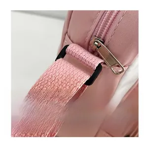 Close-up of the durable shoulder strap connection and smooth zipper on a pink bag