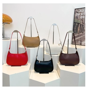 Minimalist leather baguette bags in five colors displayed on white geometric stands