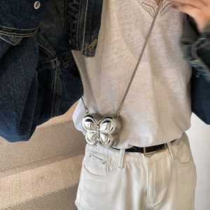 Silver butterfly metal mini chain bag with mirror finish shown as a crossbody clutch bag
