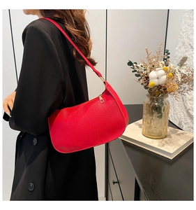 Red PU leather hobo bag styled with a black blazer showing texture and metal zipper