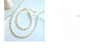 Close-up of white rice-shaped freshwater pearls with gold beads and lobster clasp hardware