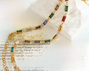 Detailed macro view of colorful baguette cut gemstones on a vintage gold chain necklace