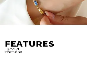 Macro detail of gold thin bracelet with rectangular blue and yellow gemstones