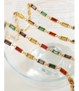 Detailed macro view of vibrant rectangular gemstones set in a vintage golden chain link
