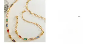 Detailed macro of 18K gold chain featuring vibrant multi-color baguette-cut crystal stones