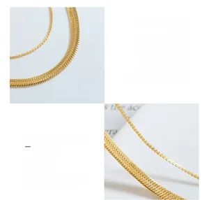 Macro detail of 18K gold plated titanium steel snake chain and twisted link necklace