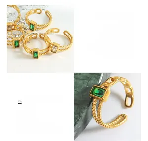 Détail de bagues en acier titane plaqué or 18K avec zircons verts et blancs sertis