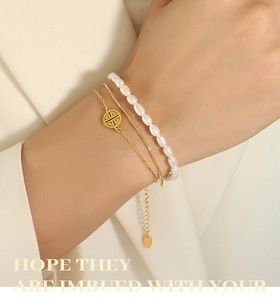 Detailed view of triple-layered gold chain bracelets with natural freshwater pearls