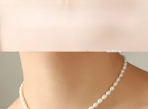 French style necklace featuring freshwater pearls and geometric letter D pendant on model