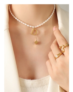 Detail of freshwater pearl necklace with gold letter D pendant and matching rings