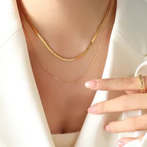 Double-layered gold blade snake chain necklace set styled on a model in a white blazer