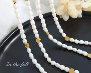 Detail of baroque freshwater pearls and gold-plated beads on an elegant necklace