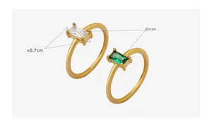 Detailed view of gold rings featuring 0.7cm rectangular white and green zircon stones