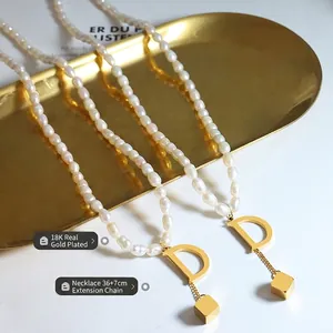 Baroque pearl necklace with 18K gold letter D pendant and elegant cube tassel