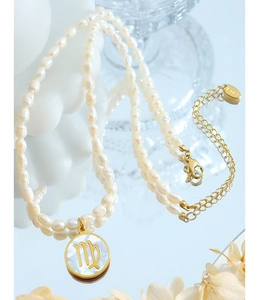 Detail of Virgo zodiac gold pendant and freshwater baroque pearls with K18 gold clasp