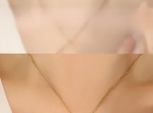 Detailed view of elegant gold curb chain necklace on model for minimalist styling