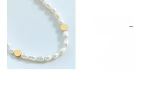 Detail of baroque freshwater pearls and gold beads on a minimalist French style necklace