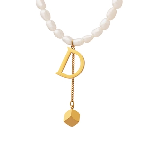 Baroque freshwater pearl necklace with gold letter D pendant and tassel cube detail
