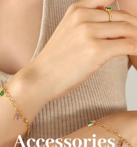 Detail of 18K gold plated bracelet and ring set with emerald and amethyst stones