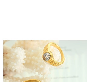 Gros plan sur une bague striée plaquée or 18 carats ornée d'un zircon rond brillant